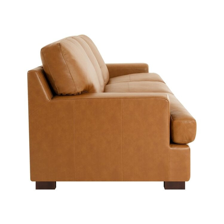 Divano moderno in vera pelle con gambe in legno e cuscino di supporto aggiuntivo